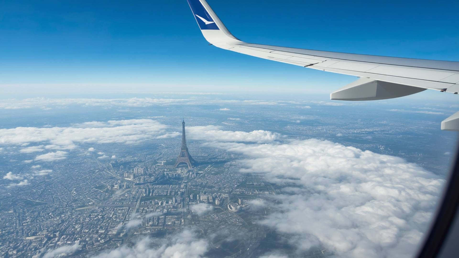 Aerial view of the wing over clouds during a flight to Paris
