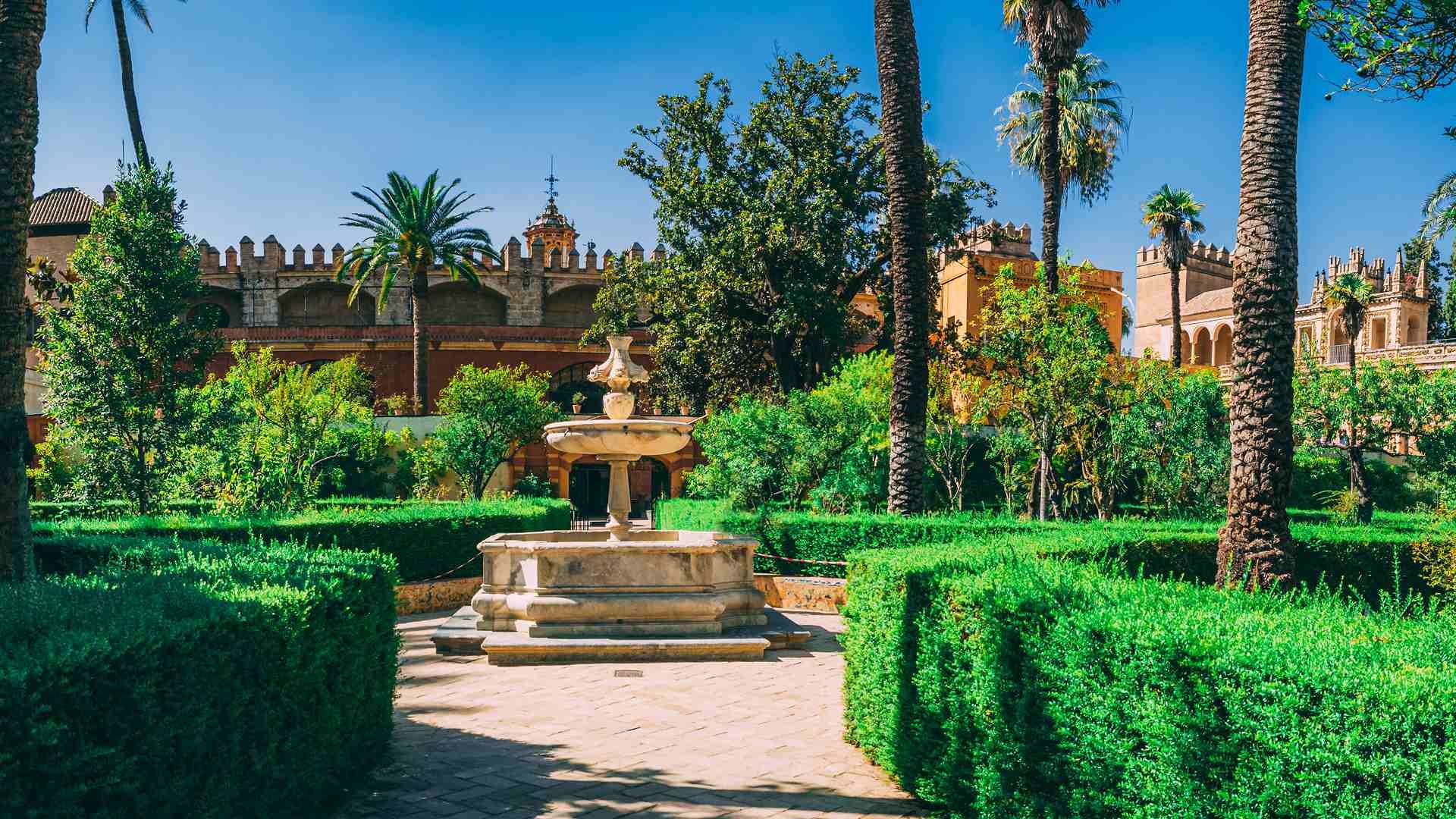 The Alcázar gardens in Seville in October in low golden light — the best time to visit Andalusia