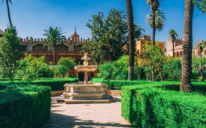 The Alcázar gardens in Seville in October in low golden light — the best time to visit Andalusia