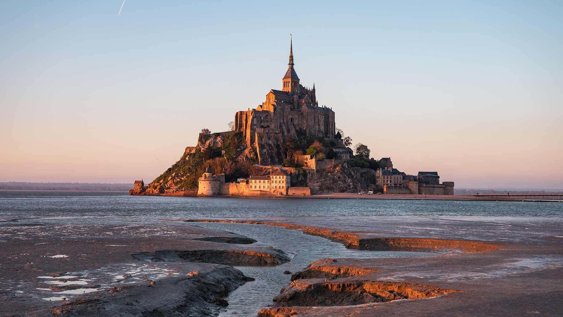 Mont-Saint-Michel at first light with the tide out — the best time to visit is early morning