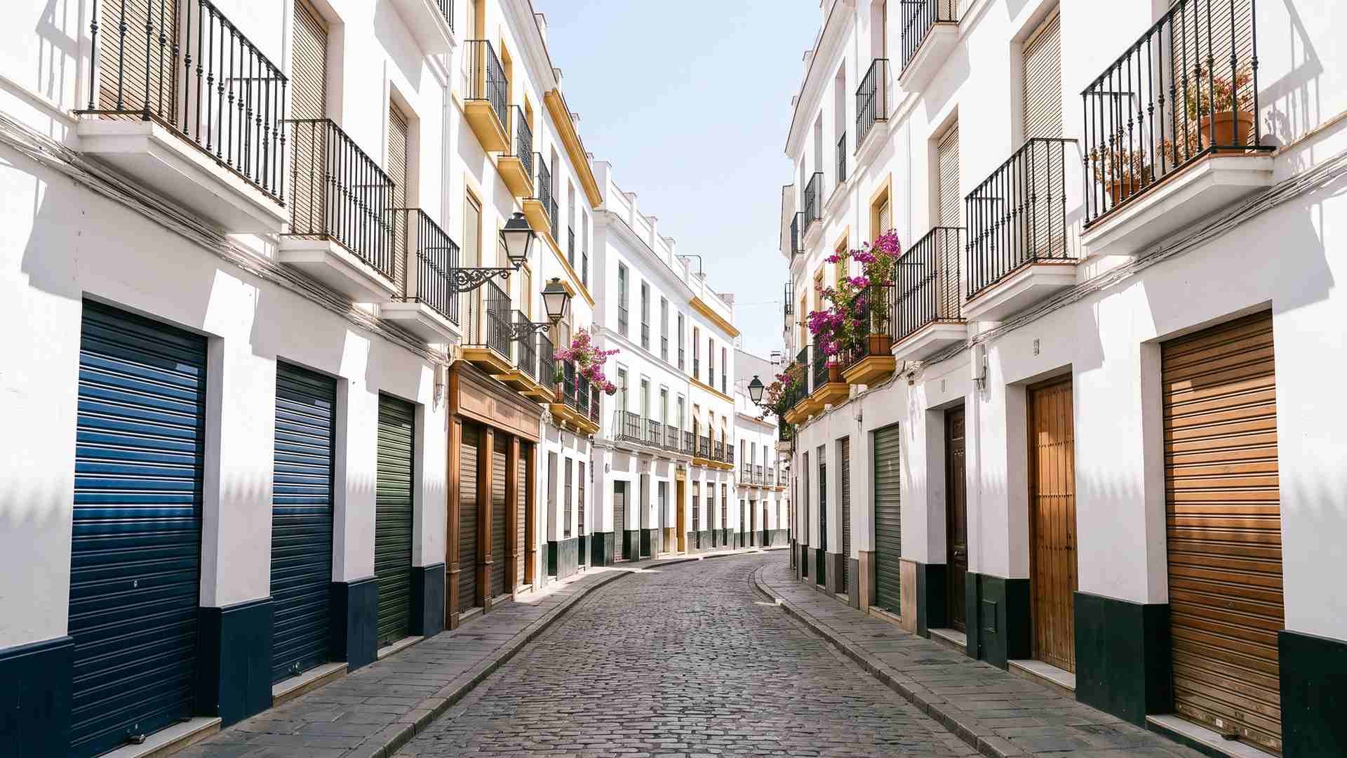 An empty Seville street at three in the afternoon in August with every shutter down