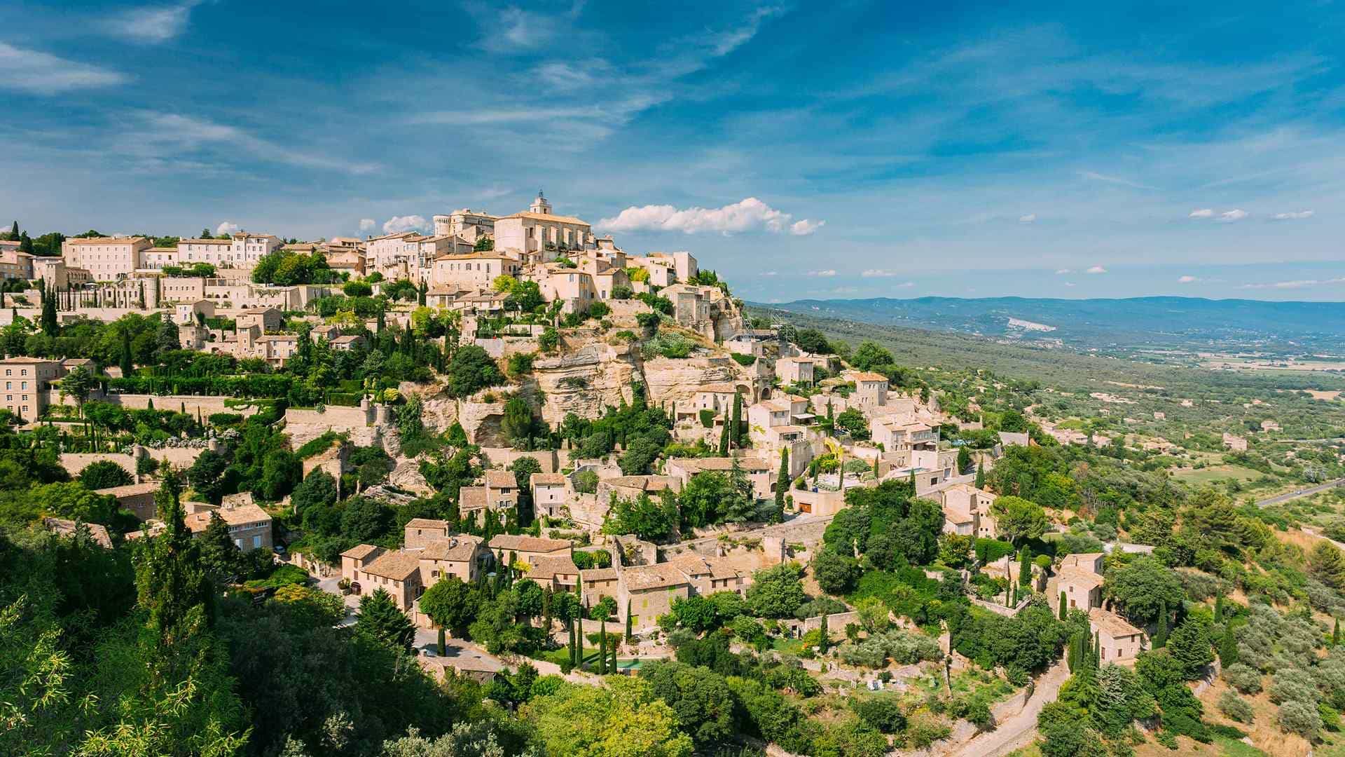 A Luberon hill village in late May with green hills and no tour coaches
